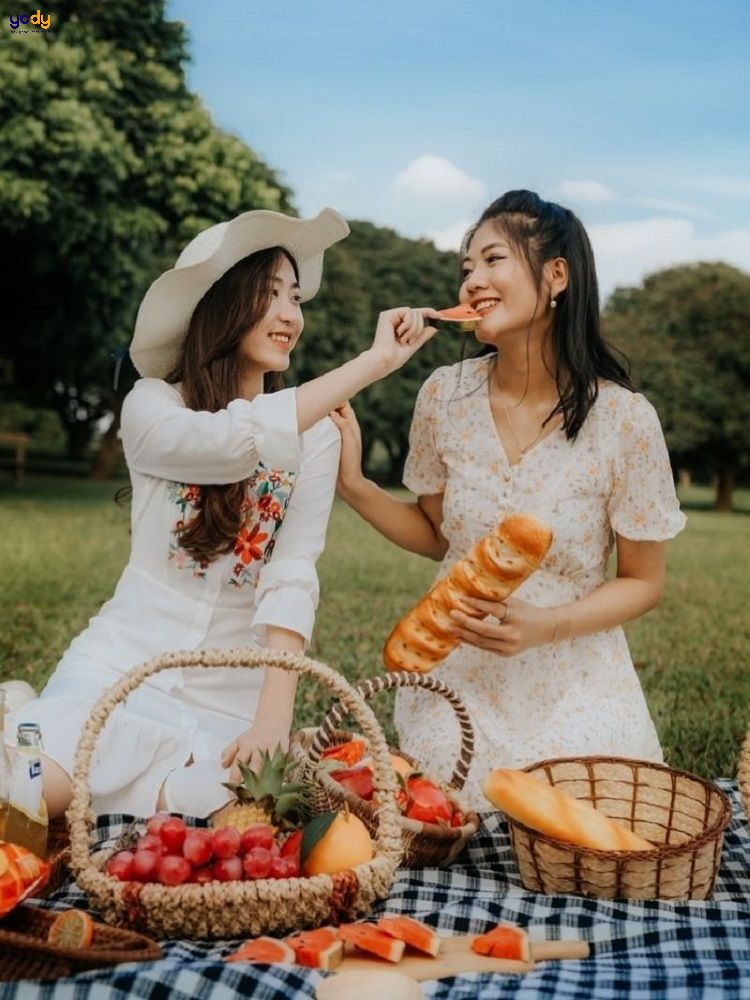 Tạo dáng chụp ảnh picnic đút đồ ăn